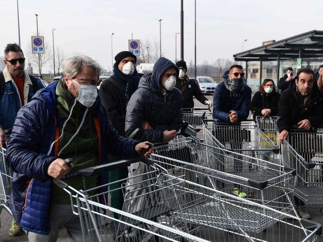 Residents wait to be given access to shop in a supermarket in small groups of 40 people in the small Italian town of Casalpusterlengo. Picture: AFP