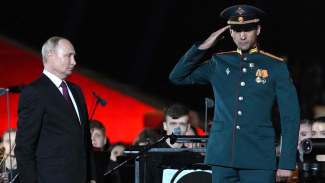 Vladimir Putin (L) stands next to tank company commander Rasim Baksikov (R) after awarding him with the honorary title of Hero of Russia. Picture; AFP.