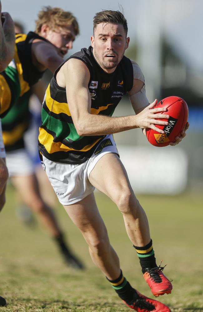 Dromana’s Joel Bateman weaves through traffic. Picture: Valeriu Campan.