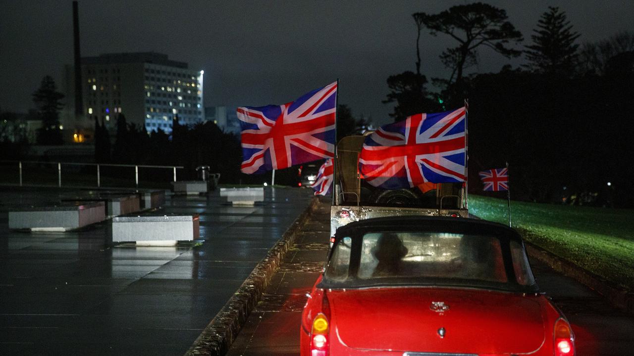 Auckland, New Zealand: A funeral convoy of British cars with Union flags paraded through the streets to the war museum on September 19. Picture: Getty Images