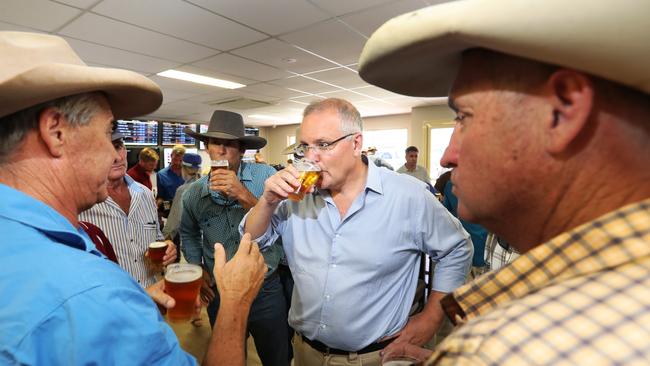 Prime Minister Scott Morrison listens to locals in Julia Creek. Picture: Nigel Hallett/News Corp