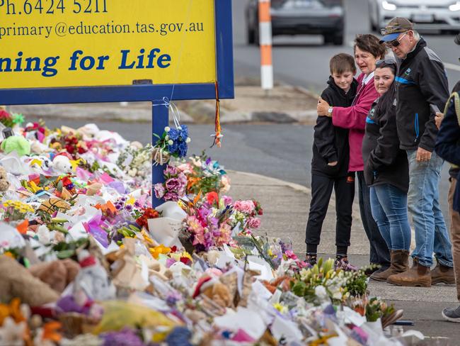 A child who whiteness the incident visit the scene with his family.Monday Pictures. Mourners pay tribute to the children who died after gust of wind swept away a jumping castle at Hillcrest Primary School Devonport Tasmania. Picture: Jason Edwards