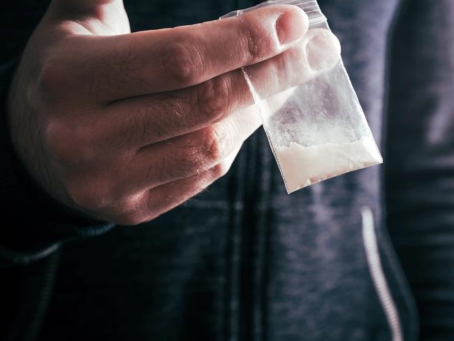 Dealing Drugs By A Man Holding One Little Bag With White Powder In His Hand . Picture: istock