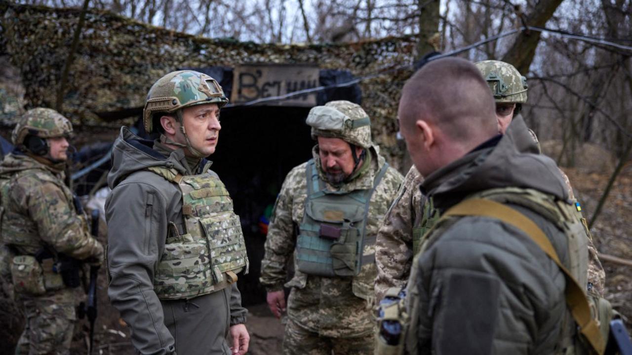 Ukrainian President Volodymyr Zelensky, left, on the frontline with Russia-backed separatists in Mariupol region. Picture: AFP