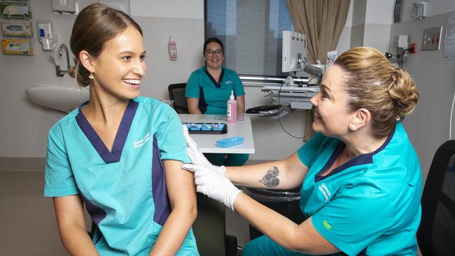 Registered nurse Zoe Park gets the first COVID-19 jab from clinical nurse consultant Kellie Kenway. Picture: Nigel Hallett