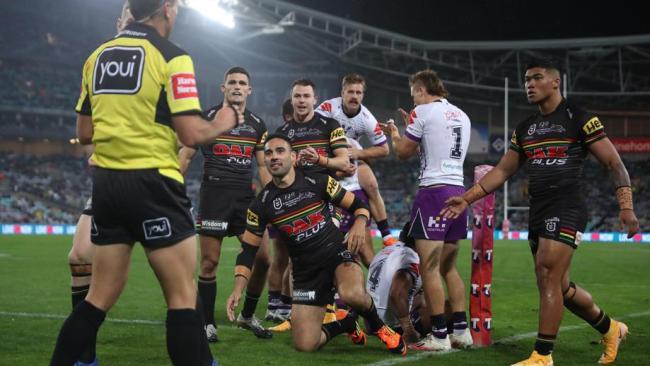 Tyrone May looks up at the referee after Justin Olam dives over.