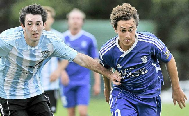 Lismore’s Jake Nind (right) tries to outrun a Ballina rival during their 5-0 romp in the Anzac Cup Football match at John Ryan Field, East Lismore. . Picture: Jay Cronan