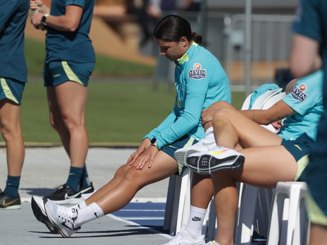 Sam Kerr sits on the sidelines while the Matildas train. Picture Lachie Millard