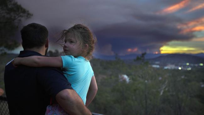 Julian Smith, 27, with his daughter Emily, 3, looking out at the fire to south of them. Picture: Gary Ramage