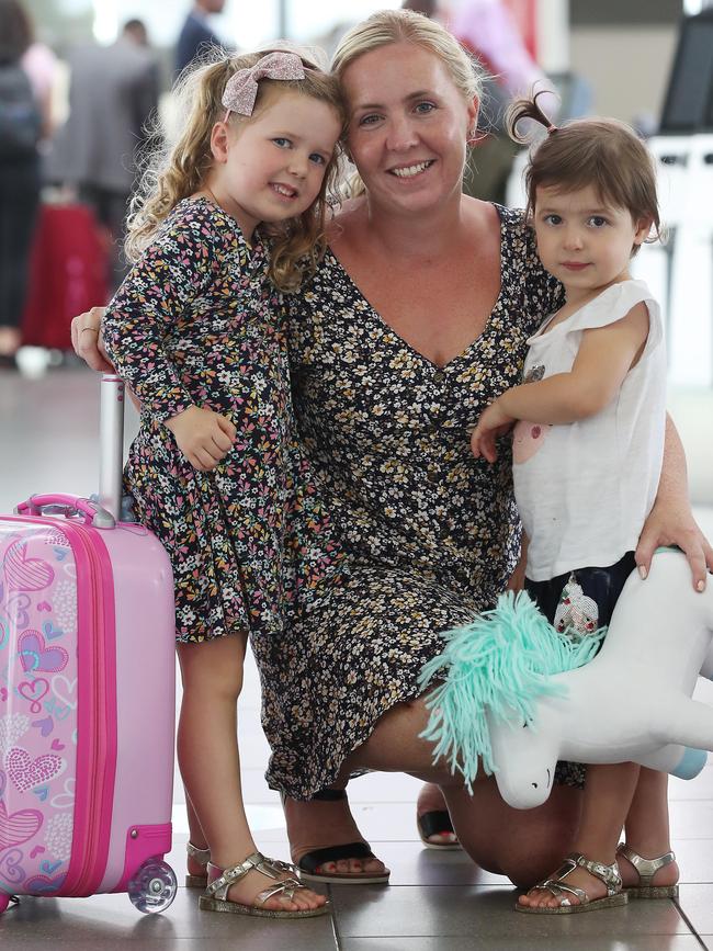 TRebecca Wilkie and her two girls, Mackenzie, 4, and Marli, 2, who were all heading back to the Sunshine Coast in Queensland to get out of Sydney. Picture: David Swift