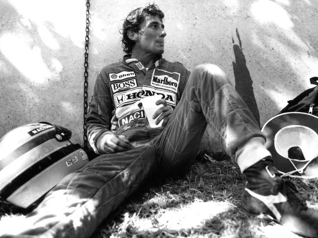 Ayrton Senna, visibly upset after colliding with a tyre barrier in Adelaide in 1990, pauses to take a drink beside the track. Picture: Jayne Russell