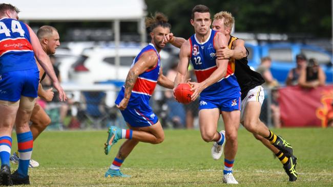 Centrals Trinity Beach playing-coach Luke Morgan looks for an option while being chased by North Cairns Tigers' Jay Kirwood. Picture: Brett Pascoe