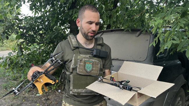 Father Serhii, a chaplain-turned-drone-pilot, shows off his 'bomber' and 'suicide' models. A $750 quadcopter can be used to destroy tanks worth millions of dollars. Picture: Maxim Tucker/The Times