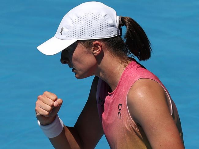 MELBOURNE, AUSTRALIA - JANUARY 18: Iga Swiatek of Poland celebrates a point against Emma Raducanu of Great Britain in the Women's Singles Third Round match during day seven of the 2025 Australian Open at Melbourne Park on January 18, 2025 in Melbourne, Australia. (Photo by Clive Brunskill/Getty Images)