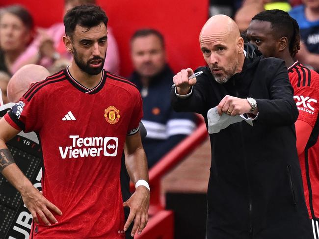 Manchester United's Dutch manager Erik ten Hag (R) gives instructions to Manchester United's Portuguese midfielder #08 Bruno Fernandes (L) during the English Premier League football match between Manchester United and Brighton and Hove Albion at Old Trafford in Manchester, north west England, on September 16, 2023. (Photo by Oli SCARFF / AFP) / RESTRICTED TO EDITORIAL USE. No use with unauthorized audio, video, data, fixture lists, club/league logos or 'live' services. Online in-match use limited to 120 images. An additional 40 images may be used in extra time. No video emulation. Social media in-match use limited to 120 images. An additional 40 images may be used in extra time. No use in betting publications, games or single club/league/player publications. /