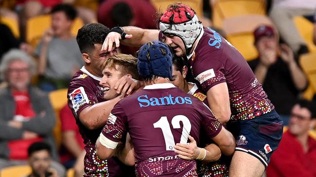 Reds players flock to Tate McDermott after he scored a try. Picture: Bradley Kanaris/Getty Images