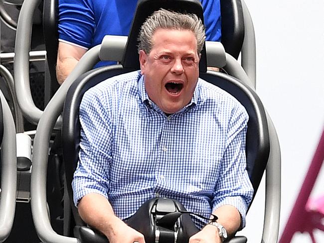 Queensland Opposition Leader Tim Nicholls (bottom right) takes a ride on the DC Rivals Hypercoaster at the Movie World theme park on the Gold Coast, Thursday, November 9, 2017. Mr Nicholls announced that the LNP, if elected, will invest $100 million to improve M1 ramps to reduce congestion. (AAP Image/Dan Peled) NO ARCHIVING