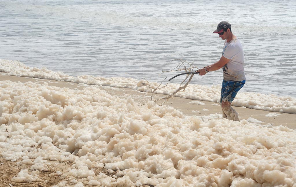 Foam covers Maroochydore Beach after heavy rain and large seas. Picture: Brett Wortman