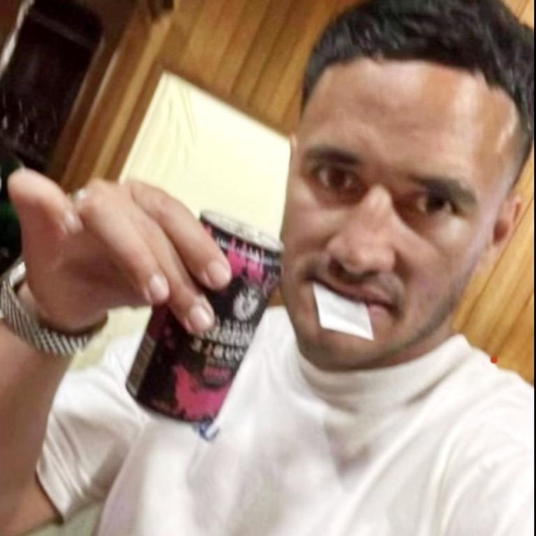 Valentine Holmes with what appears to be a bag of white powder in his mouth.