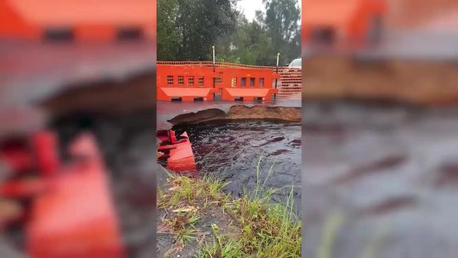 Wooli Road falls away due to fast flowing water 