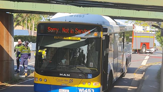 Crew work to free trapped Translink bus at Graceville.