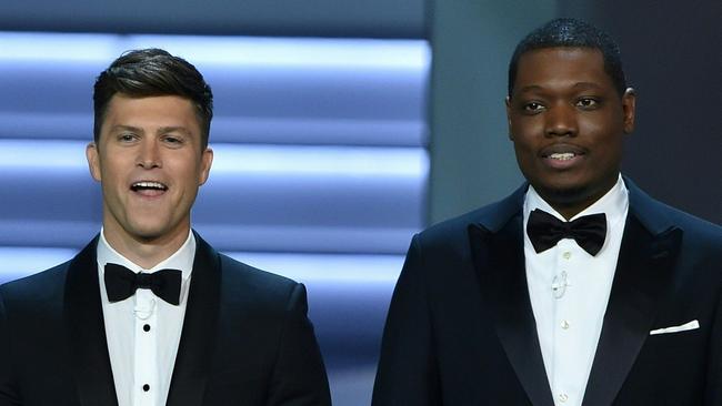 Host Colin Jost (L) and Michael Che speak onstage during the 70th Emmy Awards at the Microsoft Theatre in Los Angeles, California on September 17, 2018. (Photo by Robyn BECK / AFP)