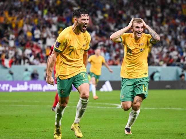 AL WAKRAH, QATAR - NOVEMBER 30: Mathew Leckie (L) celebrates with Riley McGree (R) of Australia after scoring his team's first goal during the FIFA World Cup Qatar 2022 Group D match between Australia and Denmark at Al Janoub Stadium on November 30, 2022 in Al Wakrah, Qatar. (Photo by Marvin Ibo Guengoer - GES Sportfoto/Getty Images)