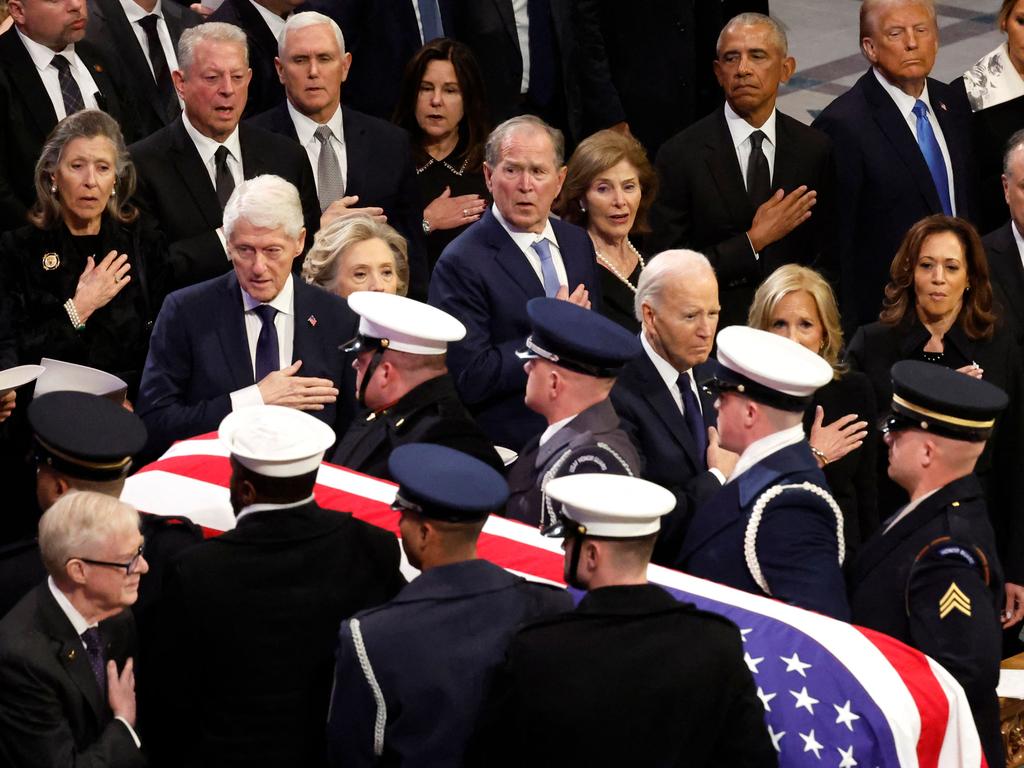 U.S. Military Body Bearers carry the flag-draped casket bearing the remains of former U.S. President Jimmy Carter.