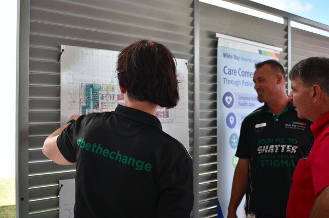 Workers look over plans for the acute mental health inpatient unit. Picture: Isabella Magee