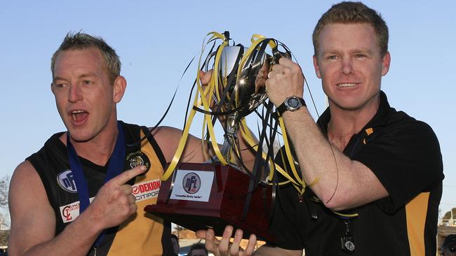 Heidelberg captain Blair Harvey and coach Phil Plunkett lift the 2008 premiership cup.