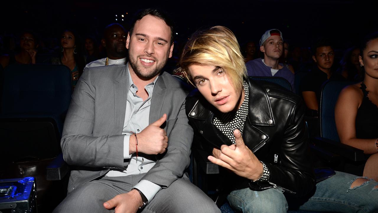 Braun with perhaps his biggest client, Justin Bieber, in 2015. Picture: Kevin Mazur/MTV1415/WireImage