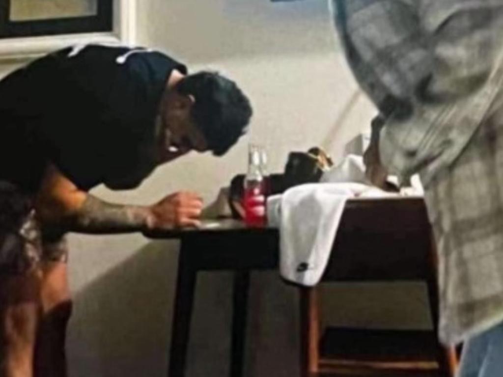 The leaked image that appears to show NRL Star Latrell Mitchell leaning over a table with a white substance on it.