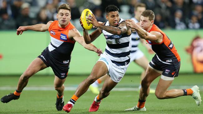 Geelong's Tim Kelly charges through two Giants. Pic: Michael Klein