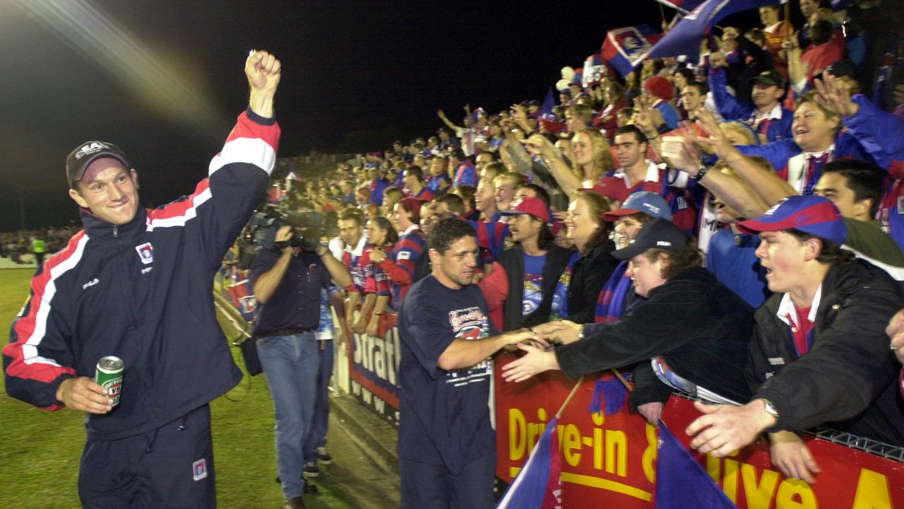 Adam MacDougall and Robbie O'Davis celebrate with Knights fans following victory in the 2001 NRL grand final. Picture: Robert McKell