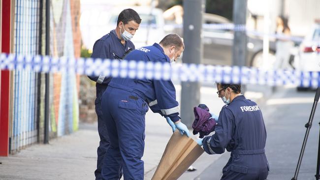 Forensic police examine items at the scene the Love Machine shooting. Picture: AAP Image/Ellen Smith