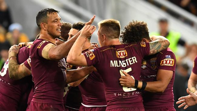 Cameron Munster (centre) celebrates with his Queensland teammates after winning Origin 3. Photo: AAP