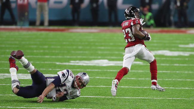 Tom Brady hits the deck as the Patriots quarterback attempts to tackle Robert Alford as he scoots away for a touchdown.