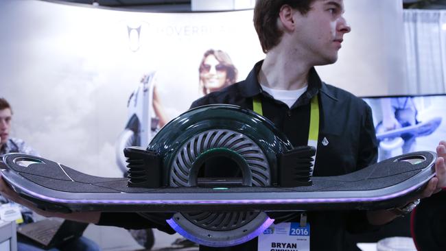 Hoverboard representative Brynn Gwynn holds a Hoverboard at CES International Thursday, Jan. 7, 2016, in Las Vegas. (AP Photo/Gregory Bull)