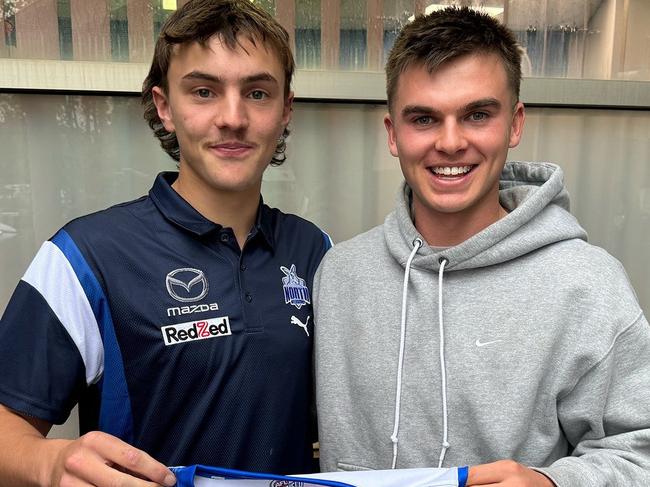 North Melbourne's newest recruit Geordie Payne catches up with fellow Roo and former Devils teammate Colby McKercher on Thursday. Picture: North Melbourne FC