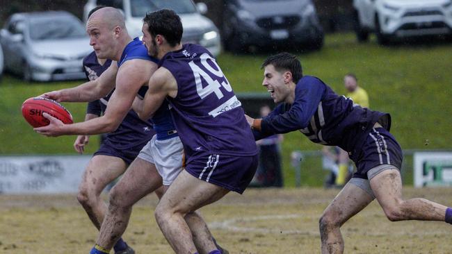 EFL: Heathmont’s John McDonald can’t escape three Templestowe tacklers. Picture: Valeriu Campan