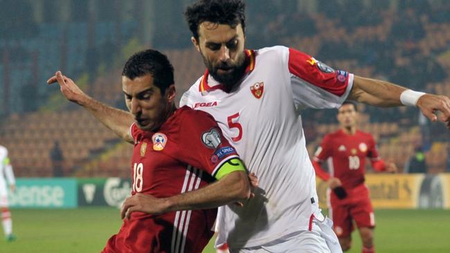 Armenia's Henrikh Mkhitaryan (L) and Montenegro's Marko Basa.