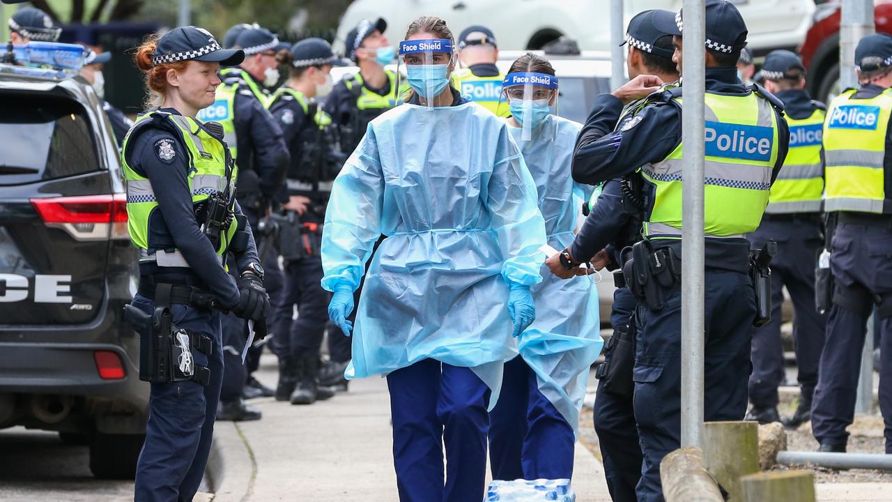 Medical staff wearing PPE walk into the Flemington Public housing flats in Melbourne. Picture: Asanka Ratnayake/Getty Images