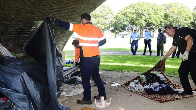 Council workers begin the removal of possessions. City of Sydney Council under Police supervision, clear away possessions from the homeless community at Wentworth park in glebe. Picture: John Appleyard