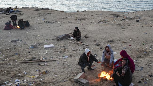 Displaced Palestinians warm themselves by a fire as they wait to return to their homes in the northern part of the Gaza Strip, Sunday, January 26, 2025, days after the ceasefire deal between Israel and Hamas came into effect. Picture: AP/Abdel Kareem Hana