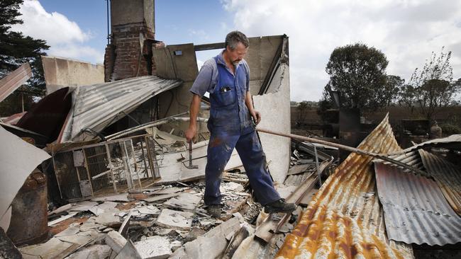 Terry Carpenter walks through what is left of his Terang home. Picture: David Caird