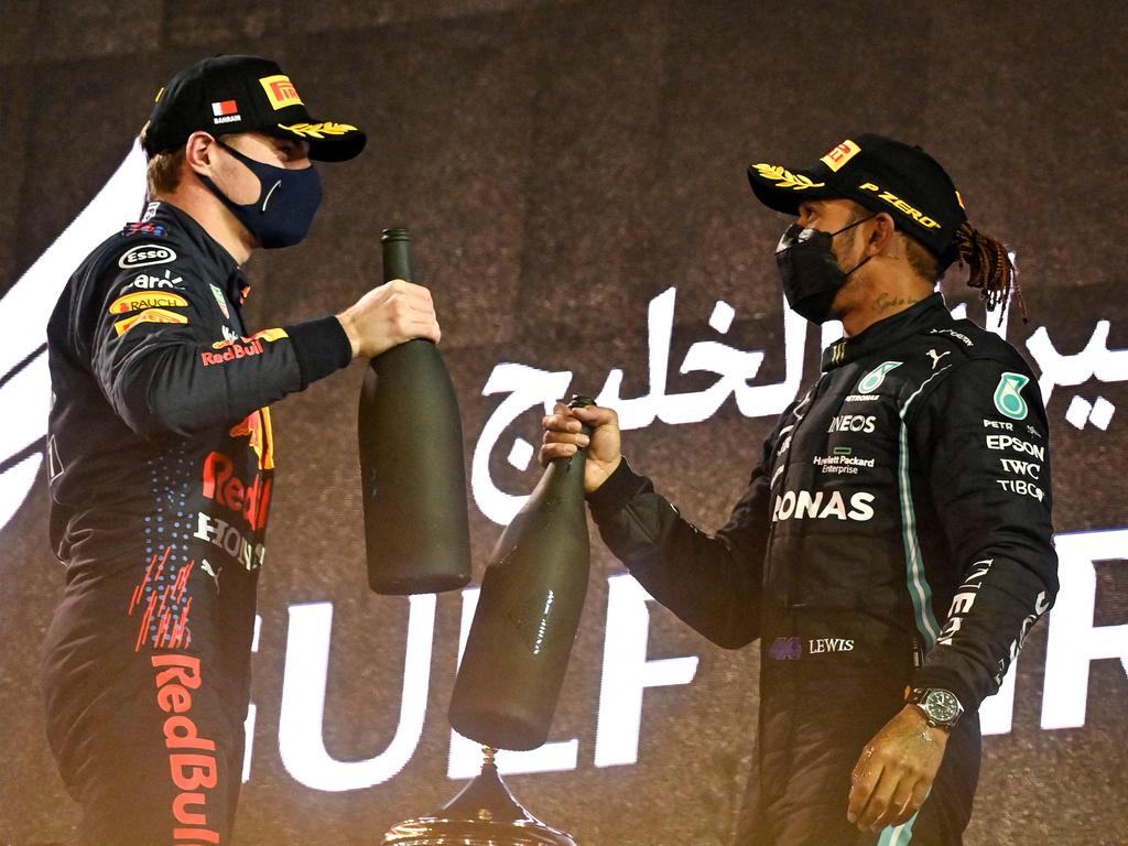 Red Bull's Dutch driver Max Verstappen congratulates Mercedes' British driver Lewis Hamilton on the podium021. (Photo by ANDREJ ISAKOVIC / AFP)