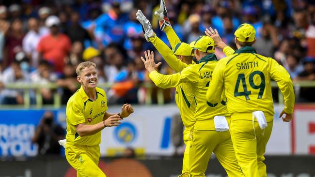 Nathan Ellis celebrates with teammates after taking the wicket of India's Virat Kohli. Picture: AFP