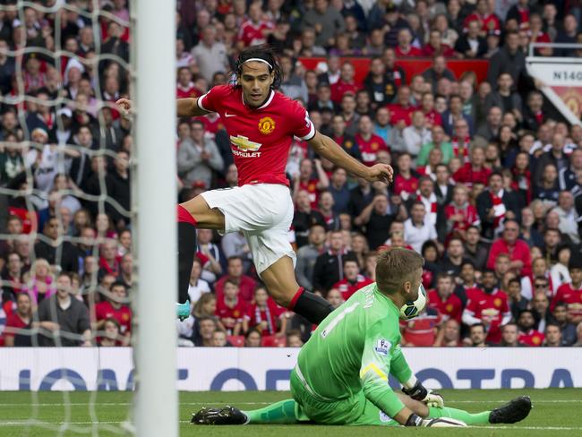 Manchester United's Radamel Falcao, left, is thwarted by Robert Green.