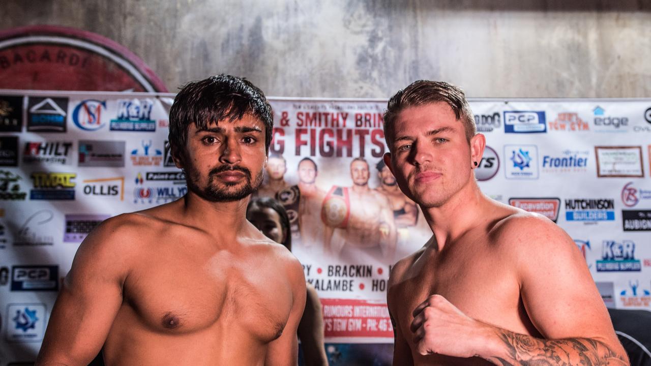 India's Balkar Singh and Toowoomba's Chris Backin come face to face at yesterday's weigh-in for their showdown tonight at Rumours International. Photo: TANNER SMITH