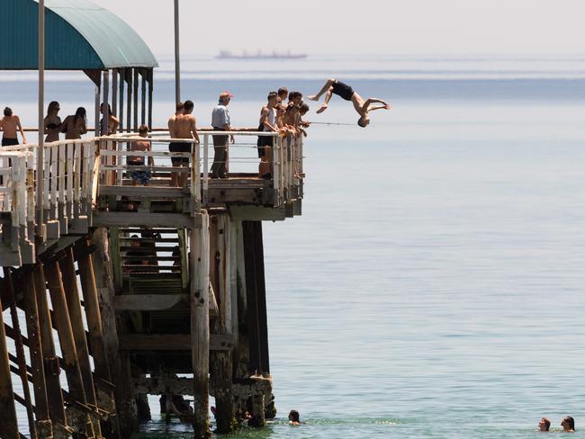 Jetty Jumpers escape the heat by cooling off at Henley Beach, 15 minutes west of Adelaide. Picture: AAP/Ben Macmahon